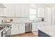 Bright kitchen with stainless steel appliances, white cabinets, subway tile backsplash and wood floors at 5210 Kelly St, Charlotte, NC 28205