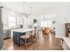 Open-concept kitchen and living area with a large island, stainless steel appliances, and hardwood floors at 5210 Kelly St, Charlotte, NC 28205