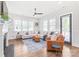 Bright living room with hardwood floors, many windows, a ceiling fan, and comfortable seating at 5210 Kelly St, Charlotte, NC 28205