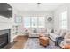 Cozy living room with a fireplace, built-in shelving, hardwood floors, and comfortable sectional sofa at 5210 Kelly St, Charlotte, NC 28205