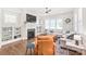 Comfortable living room with fireplace, built-in shelving, a TV, hardwood floors, and sectional sofa at 5210 Kelly St, Charlotte, NC 28205