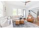 Bright living room with hardwood floors, many windows, a comfortable seating area, and ceiling fan at 5210 Kelly St, Charlotte, NC 28205