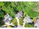 Aerial view of the home nestled among lush trees with a driveway and beautiful landscaping at 5238 Downing Creek Dr, Charlotte, NC 28269
