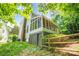Home exterior showing a screened porch and mature trees along a fenced yard at 5238 Downing Creek Dr, Charlotte, NC 28269