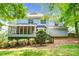 The back of this home features a screened porch, deck, and beautifully maintained landscaping at 5238 Downing Creek Dr, Charlotte, NC 28269