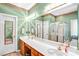 Bathroom features a double vanity, large mirror, tiled flooring, and green walls at 5238 Downing Creek Dr, Charlotte, NC 28269