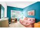 Cozy bedroom featuring a comfortable bed near a window, complemented by a small desk at 5238 Downing Creek Dr, Charlotte, NC 28269