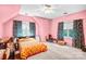 Pink bedroom boasts abundant natural light, ceiling fan, and playful zebra print curtains at 5238 Downing Creek Dr, Charlotte, NC 28269