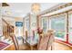 Dining room with floral wallpaper, hardwood floors, and a bright bay window at 5238 Downing Creek Dr, Charlotte, NC 28269