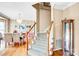 Elegant foyer with wood flooring, staircase, and a view into the dining area, creating a welcoming entrance at 5238 Downing Creek Dr, Charlotte, NC 28269