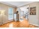 Inviting hallway with hardwood floors, crown molding, and an open view of the dining room and staircase at 5238 Downing Creek Dr, Charlotte, NC 28269