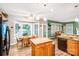 Bright eat-in kitchen featuring an island, granite countertops, and a breakfast nook with large windows at 5238 Downing Creek Dr, Charlotte, NC 28269
