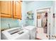 Functional laundry room with modern washer and dryer, ample storage, and convenient access to the backyard at 5238 Downing Creek Dr, Charlotte, NC 28269