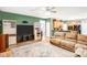 Spacious living room with hardwood floors, a large entertainment center, and comfortable seating at 5238 Downing Creek Dr, Charlotte, NC 28269