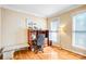 Well-lit office with hardwood floors, a built-in desk, and large windows offering natural light at 5238 Downing Creek Dr, Charlotte, NC 28269
