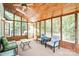 Inviting sunroom featuring wood ceiling, skylight, and walls of windows offering serene backyard views at 5238 Downing Creek Dr, Charlotte, NC 28269
