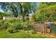 Backyard garden featuring a variety of plants, a tiered wooden planter, and a green drum at 529 Dedmon Dr, Charlotte, NC 28216