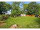 Expansive backyard featuring a shed, greenery, and a freshly mowed lawn at 529 Dedmon Dr, Charlotte, NC 28216