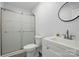 This modern bathroom features a glass shower, white vanity, and modern finishes at 529 Dedmon Dr, Charlotte, NC 28216