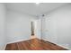 Bedroom featuring neutral walls, wood-look flooring, and an adjacent bathroom at 529 Dedmon Dr, Charlotte, NC 28216