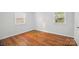 This bright bedroom is enhanced by beautiful wood flooring and natural light at 529 Dedmon Dr, Charlotte, NC 28216