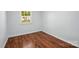This bright bedroom is enhanced by beautiful wood-look flooring and a bright window at 529 Dedmon Dr, Charlotte, NC 28216