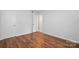 Bright bedroom featuring neutral walls and beautiful wood-look flooring at 529 Dedmon Dr, Charlotte, NC 28216