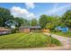 Charming brick home with a well-manicured lawn and private driveway on a sunny day at 529 Dedmon Dr, Charlotte, NC 28216