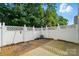 This backyard patio has privacy fence, small garden area with shade and sunny areas at 541 River Park Rd, Belmont, NC 28012