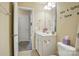 Bright bathroom features a white vanity, a mirror, and a door leading to another room at 541 River Park Rd, Belmont, NC 28012
