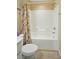 Bathroom features toilet and tub-shower combination with beige shower curtain at 541 River Park Rd, Belmont, NC 28012