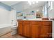 Bathroom with tub-shower, vanity with storage, and decorative mirror at 541 River Park Rd, Belmont, NC 28012
