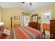 Comfortable bedroom with decorative furniture, a ceiling fan, and an en-suite bathroom at 541 River Park Rd, Belmont, NC 28012