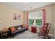 Bedroom features gray futon, rocking chair and a window providing natural light at 541 River Park Rd, Belmont, NC 28012