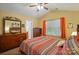 Spacious bedroom with a large window, ceiling fan, and decorative mirror, dressers and bedside tables at 541 River Park Rd, Belmont, NC 28012