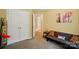 Bedroom with open closet, tan carpet, adjacent to bathroom and living area at 541 River Park Rd, Belmont, NC 28012