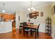 Open dining room features a wood table, decorative wall shelves, and a view into the kitchen at 541 River Park Rd, Belmont, NC 28012