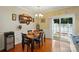 Charming dining room with wood floors, stylish light fixture, and sliding glass door to the backyard at 541 River Park Rd, Belmont, NC 28012