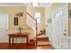 Entryway showcasing a wooden table, staircase, and hardwood floors, creating a warm and inviting welcome at 541 River Park Rd, Belmont, NC 28012