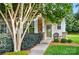 A welcoming home exterior featuring a stone facade accent, inviting front door with wreath, and manicured landscaping at 541 River Park Rd, Belmont, NC 28012