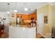 The kitchen has stainless steel appliances, stone countertops, wood cabinets and a breakfast bar at 541 River Park Rd, Belmont, NC 28012