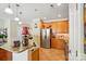 Kitchen with stainless steel appliances, wood cabinets, and stone countertops, open to living space at 541 River Park Rd, Belmont, NC 28012