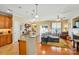 Open-concept living area featuring a kitchen island, cozy seating, a fireplace, and seamless flow for entertaining at 541 River Park Rd, Belmont, NC 28012