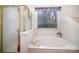 Bright bathroom with a tub, shower, and a large garden window providing natural light at 5550 Monticello Nw Dr, Concord, NC 28027
