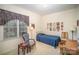 Bright bedroom with a twin bed, side table, desk and large picture window at 5550 Monticello Nw Dr, Concord, NC 28027