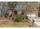 Charming brick home with an attached garage and landscaped front yard featuring a beautiful blooming tree at 5550 Monticello Nw Dr, Concord, NC 28027