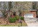 Charming brick home with an attached garage and landscaped front yard featuring a beautiful blooming tree at 5550 Monticello Nw Dr, Concord, NC 28027