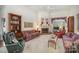 Inviting living room featuring a fireplace, plush seating, and a ceiling fan at 5550 Monticello Nw Dr, Concord, NC 28027