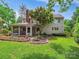 Spacious backyard featuring a fire pit and screened-in porch, ideal for outdoor relaxation and entertaining guests at 5716 Trimmings Ct, Charlotte, NC 28226
