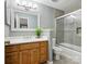 Bright bathroom with a glass enclosed shower, wooden vanity, and white countertop offering a clean and modern look at 5716 Trimmings Ct, Charlotte, NC 28226
